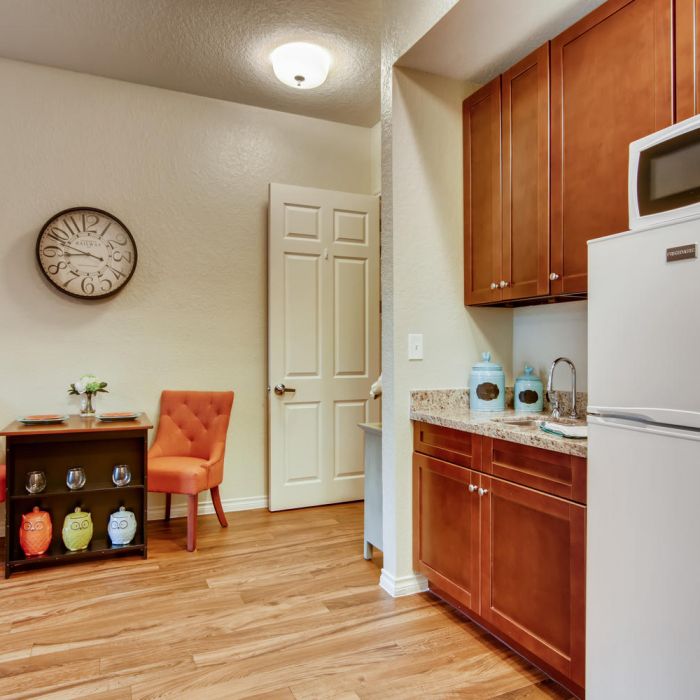 Cozy kitchen at The Terraces at Kingwood, featuring wooden cabinets, a dining nook, and modern amenities for comfortable senior living.