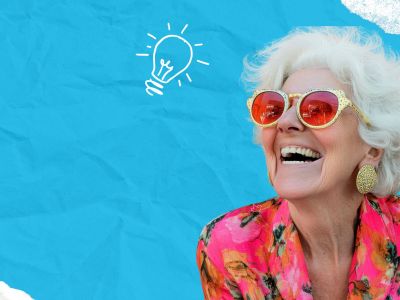 Smiling older woman in bright clothes and sunglasses, with a drawn lightbulb above her head, dreaming of senior living adventures.