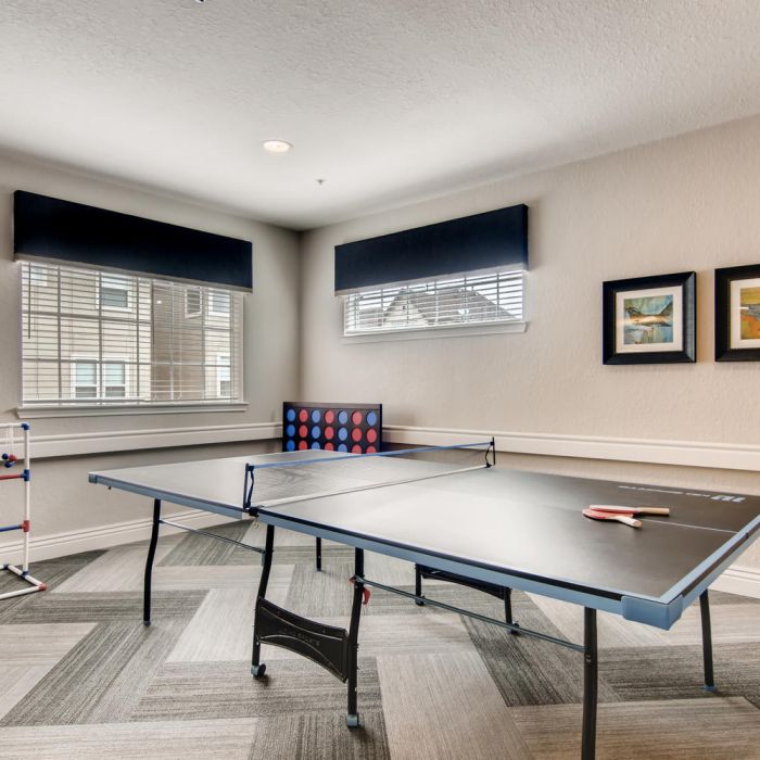 A game room at The Terraces at Kingwood with table tennis, Connect Four, ladder toss, and framed art enriches Kingwood senior living.