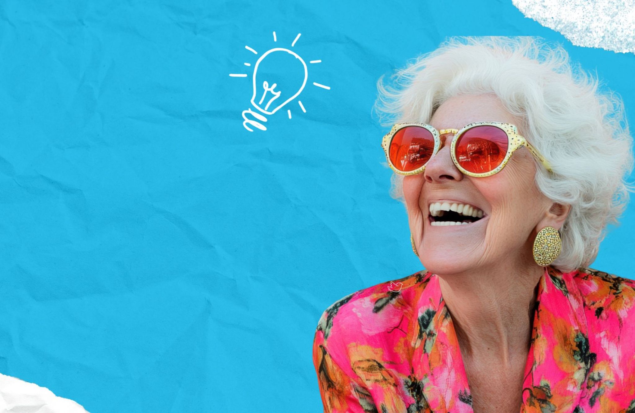 Smiling older woman in bright clothes and sunglasses, with a drawn lightbulb above her head, dreaming of senior living adventures.